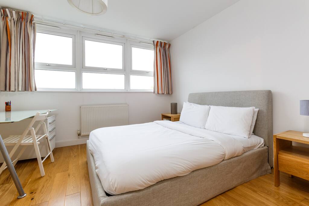 The master bedroom is very light and airy with chic wooden floors and a classic decor.