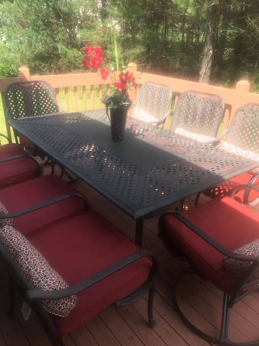 Outdoor deck ready for summer fun with gas grill and patio set