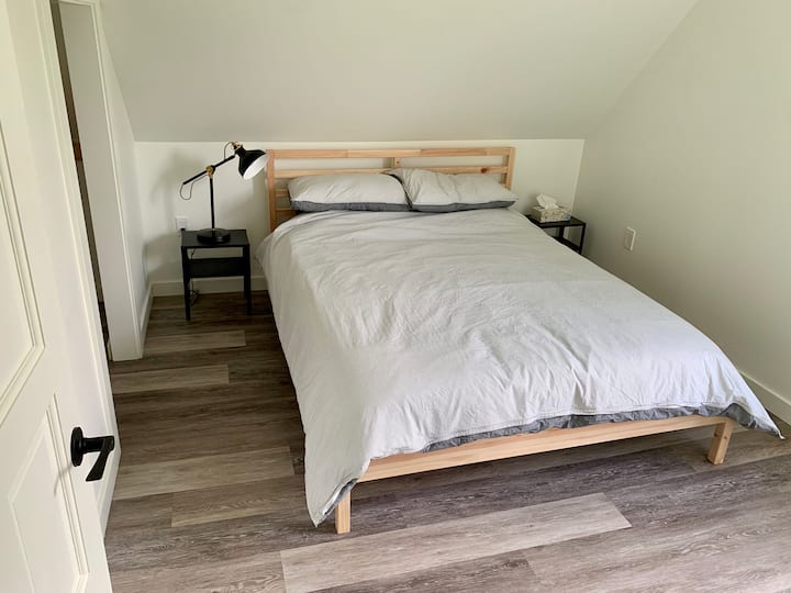Queen bed in upstairs bedroom.