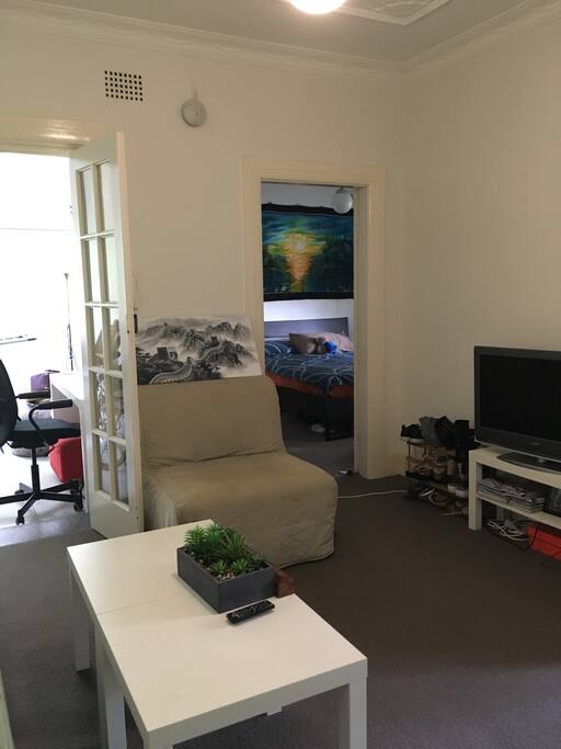 Living room. Connects to study (sunroom), ensuite, and kitchen.Includes cable TV, Chair/pullout single bed, and couch.