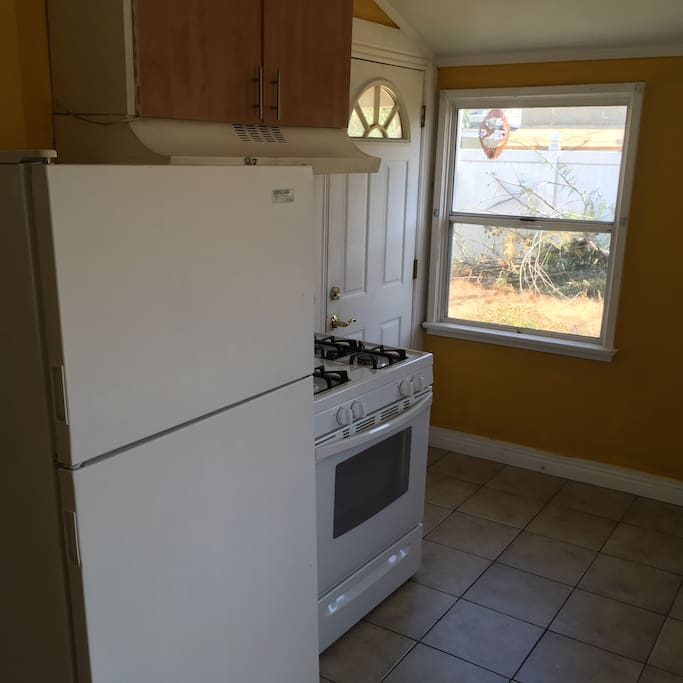 Kitchen with fridge, microwave, and gas stove