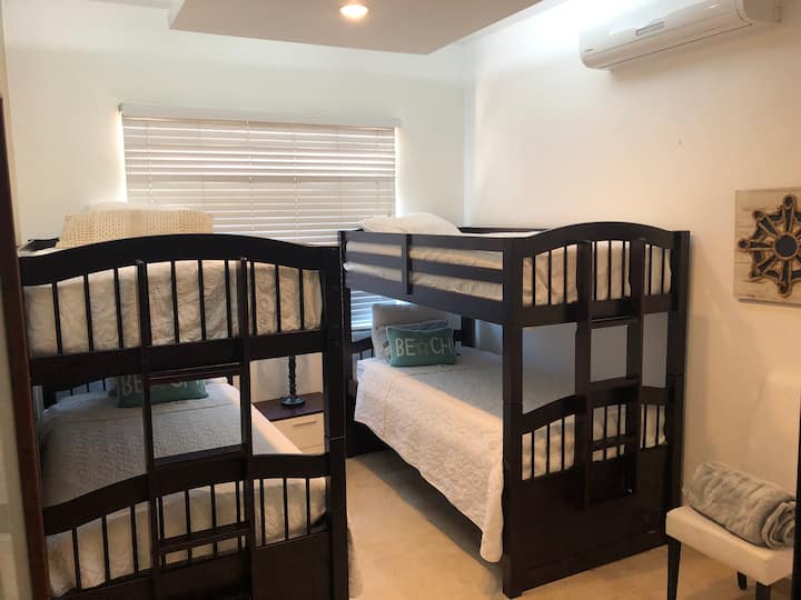 2 twin bunked bed for 4 guess, 42” tv, ac, closet, 1 desk.