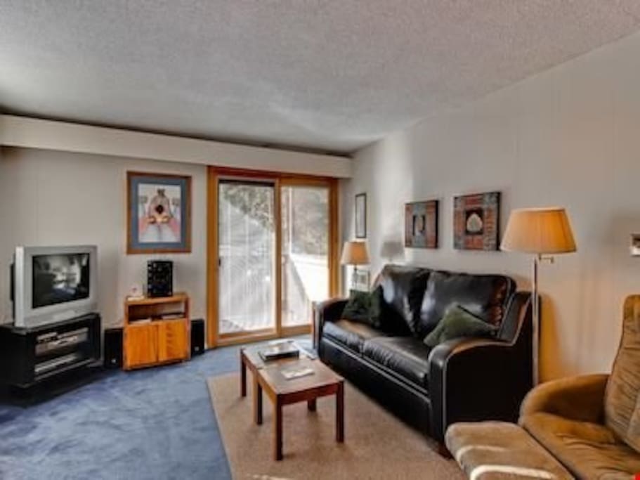 Relax in the cozy living area, complete with comfortable sofas