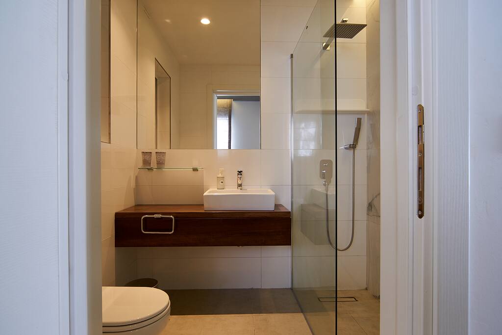 Timber vanity unit with glass shelf.