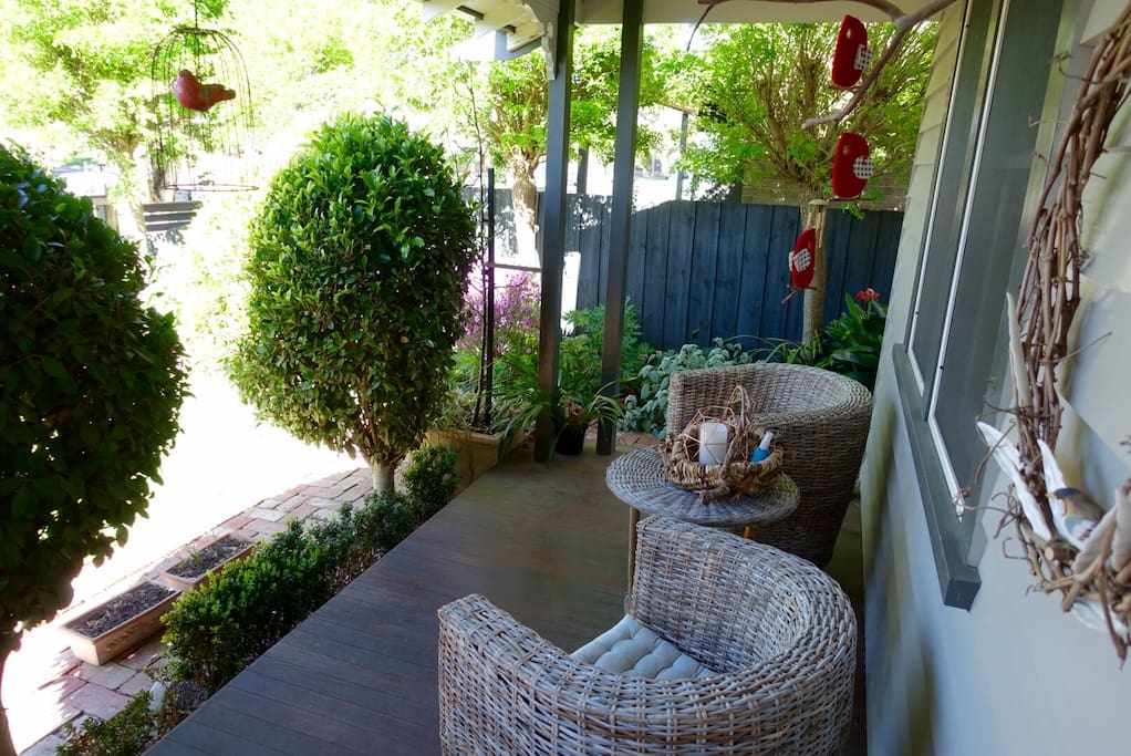 Front covered deck with beautiful garden setting