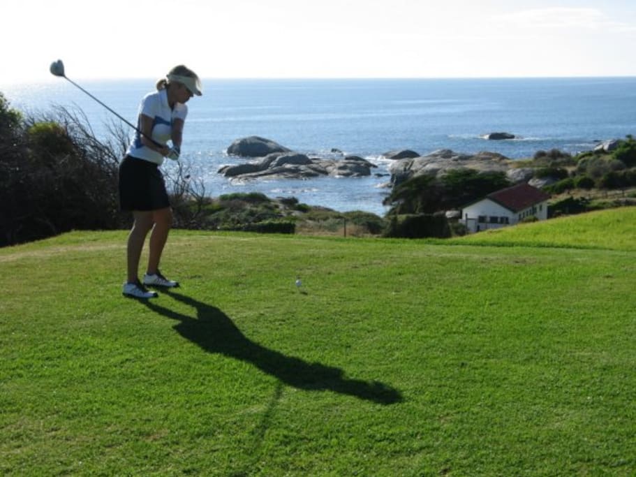 Lady golfer on the 4th Tee Box with Windmill Beach below. Stroll across the road to the course.