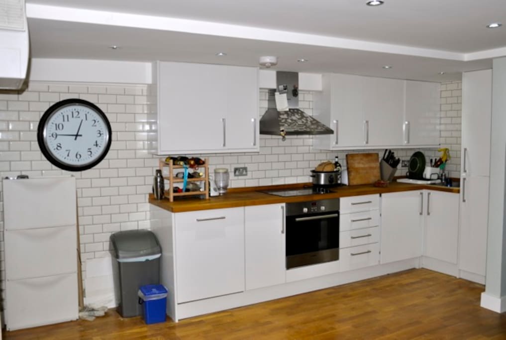 fully equipped kitchen with washer/dryer and full fridge