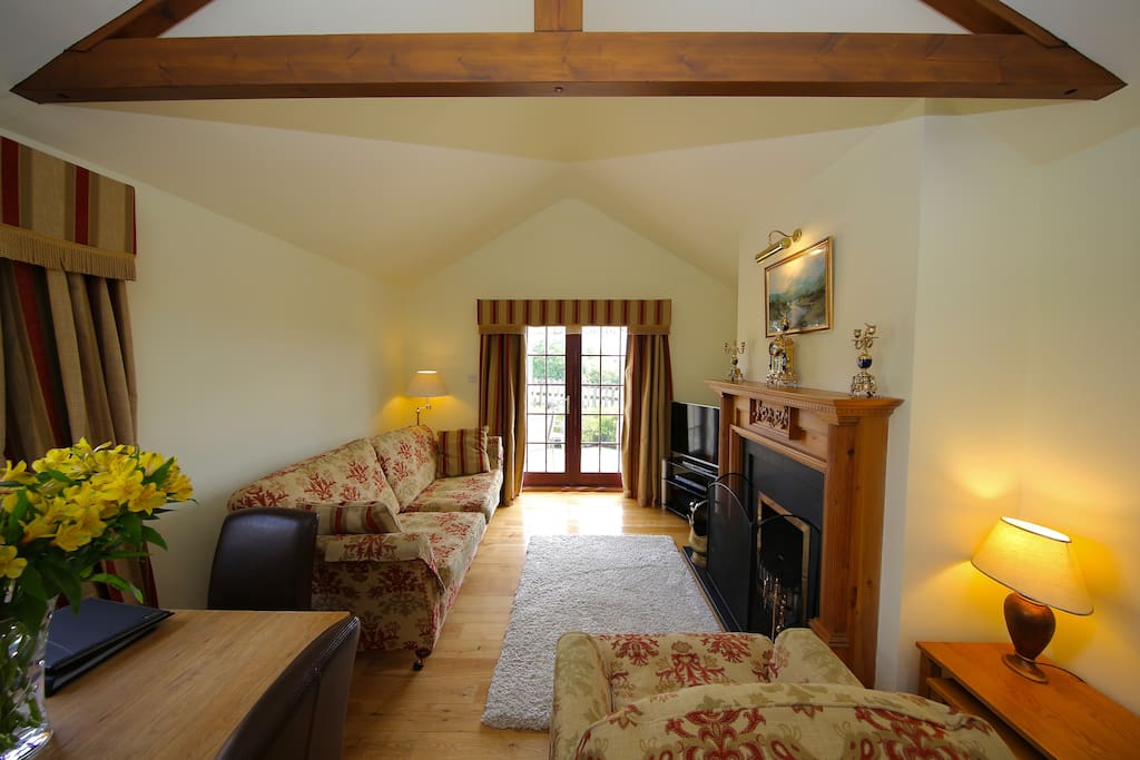 Cosy living room with fireplace, TV, extensive DVD collection and dining area.