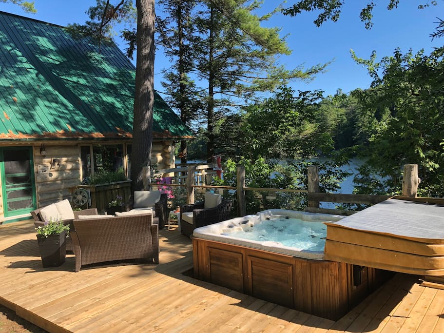 Hot tub, upper deck, glass panel railing overlooking the lake.