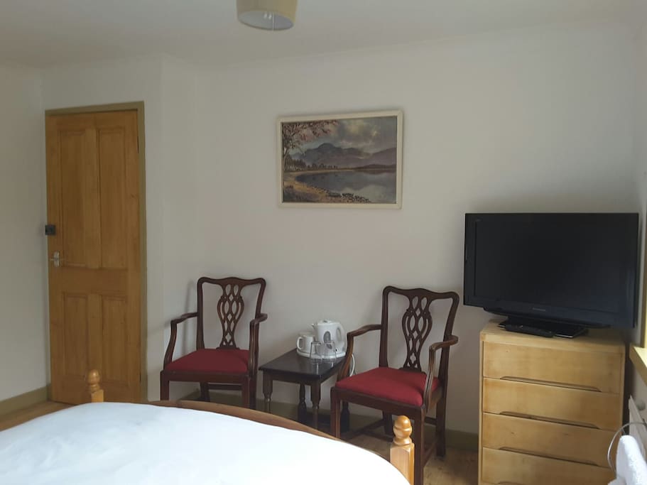 Room has a TV, seating and tea/coffee making facilities.