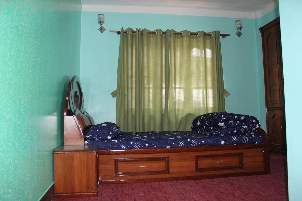 Bedroom with attached bathroom and cupboard.