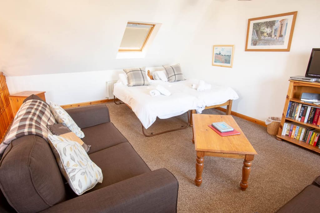 Open plan upstairs living room, showing beds
