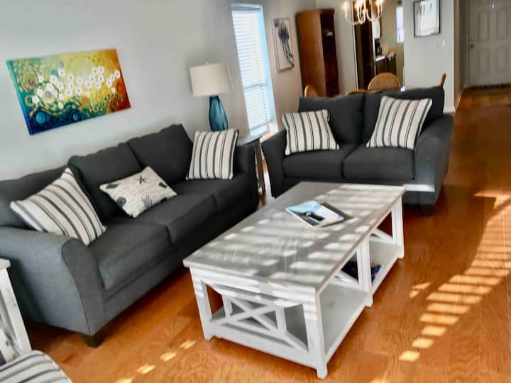 The new living room features a comfortable couch, love seat, lounge chair and a 65" inch Smart HDTV.  It is a great setting to relax at night playing games or watching a movie.