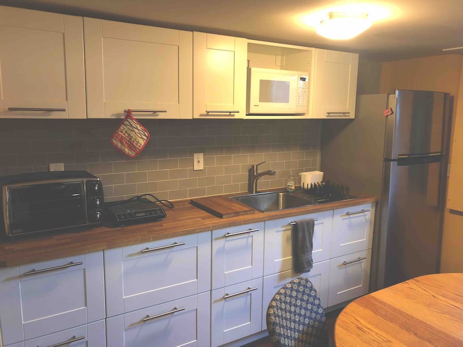 A fully stocked kitchenette will help you to cook breakfast, or full meals, while you’re here. Amenities include a full sized fridge, microwave, large toaster oven, induction hot plate, sink, dishes, silverware, cups, pots and pans, basic spices, etc