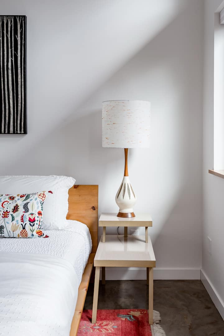A mix of mid-century treasures and hand-crafted modern furnishings  make the space feel welcoming and cozy.