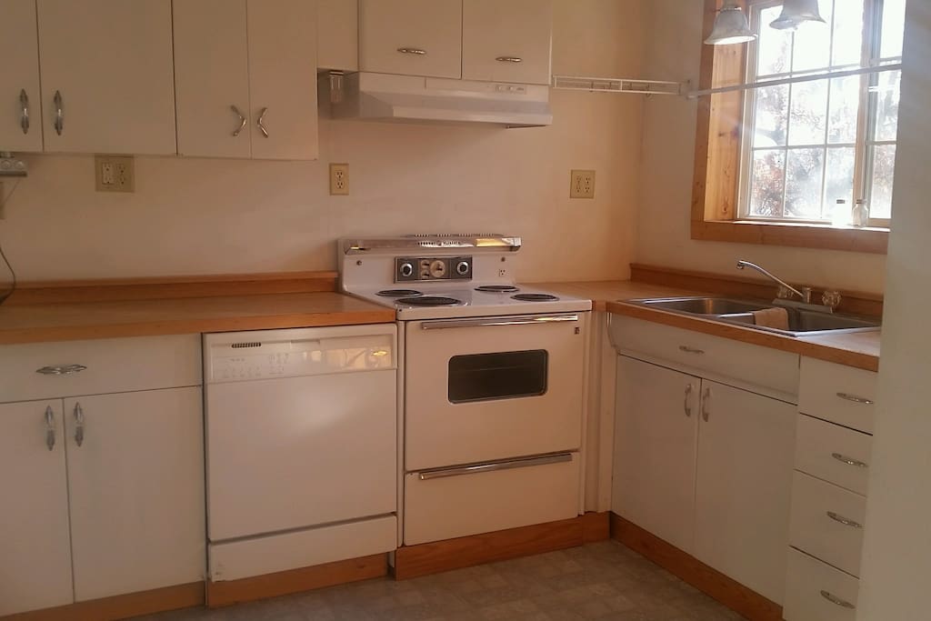 Stainless Steel double sided sink, electric range, dishwasher.