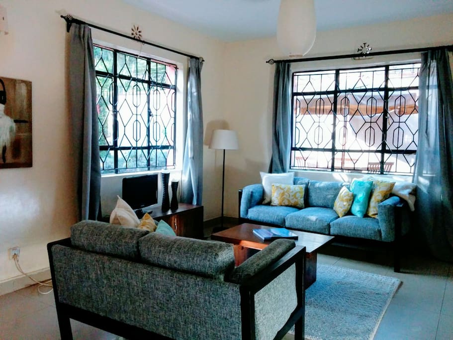 The living room has an abundance of light and adequate space to move around.