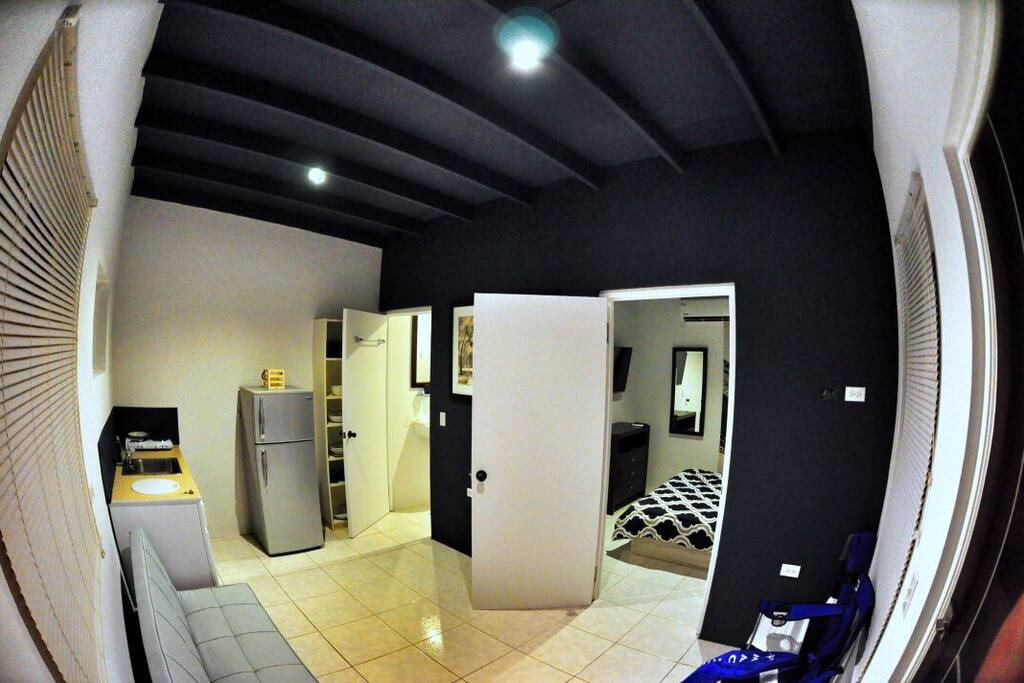 Living room with couch / kitchen and stove / full fridge , walk in to master bedroom / bathroom . All seperated / private .
