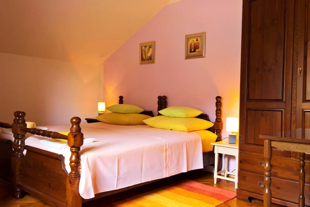 Master bedroom on the second floor with king size bed in antique style