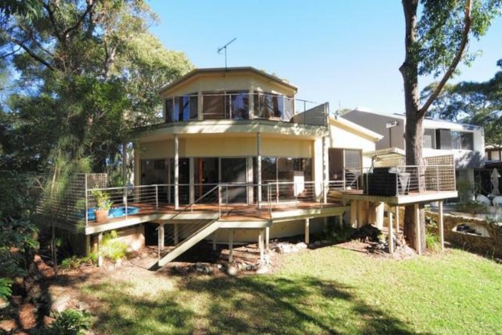 Sit on your wrap around deck, take in the view of the tree tops and listen to the waves and colourful birdlife.