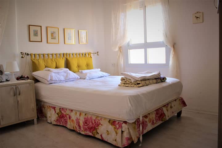 Welcome to the sunlit master bedroom, complete with a cozy en suite bathroom. A haven of comfort and relaxation awaits you.