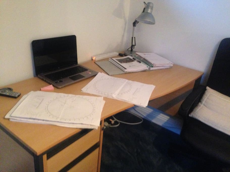 Ample desk space for laptops and work papers.
