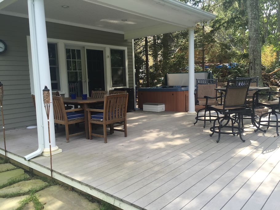 Living room leads out to covered deck and hot tub