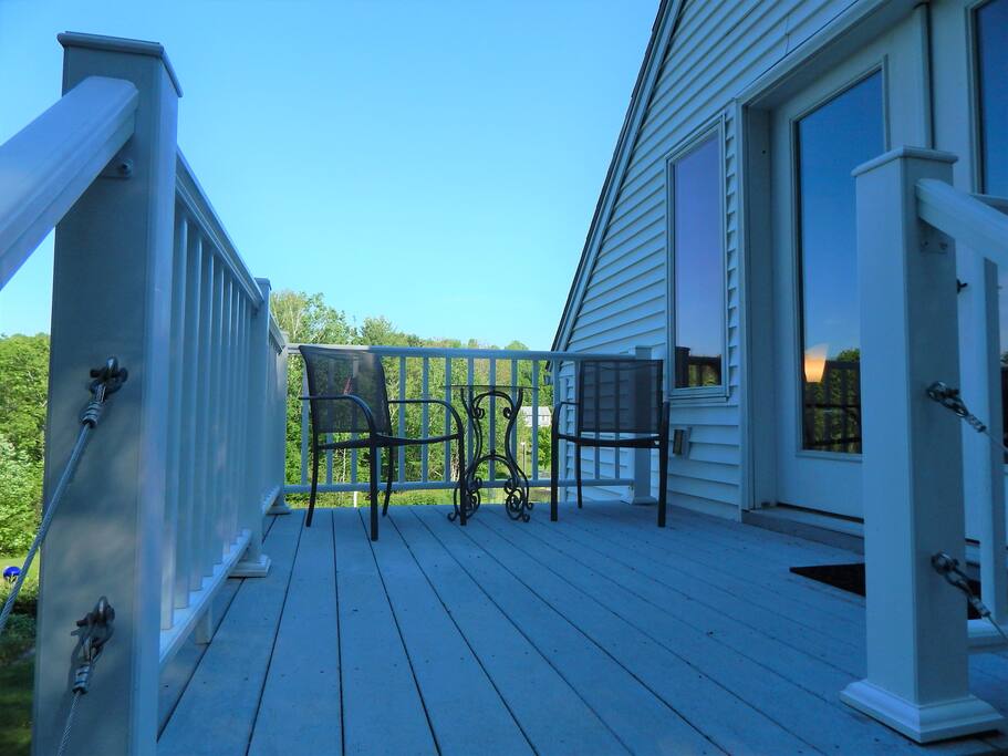 Second story entrance to apartment with quiet deck to overlook the gardens and beautiful landscape.