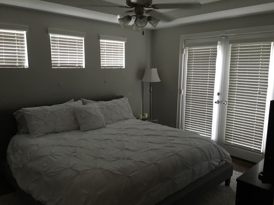 Master Bedroom with King Bed and Patio Access.