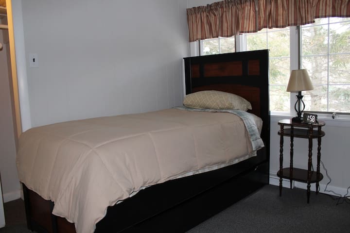 Twin mattress bedroom - we can provide a blow up mattress if needed.  The room includes a closet with a laundry basket for clothes, and an alarm clock with a USB phone charger.