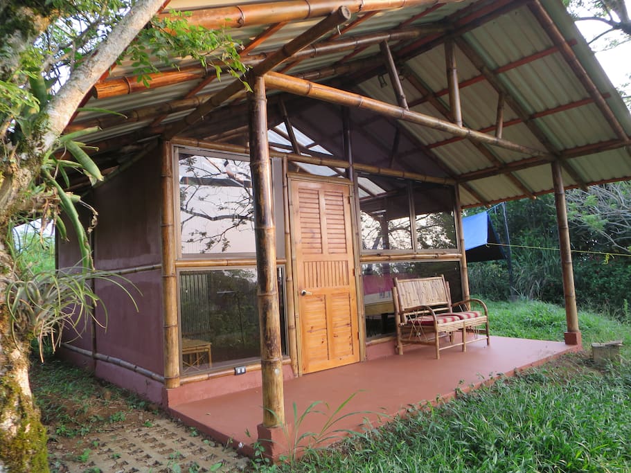 The bamboo cabin is built with native materials and sports a glass window wall and a great view of the distant Talamanca Mountains.