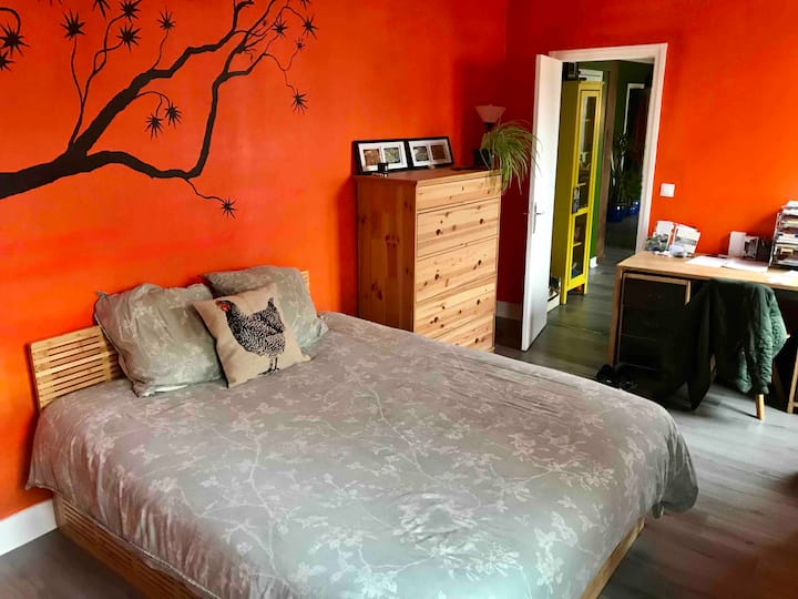 Sovrum med dubbelsäng, byrå, skrivbord, garderob, 2 fönster gatuvy