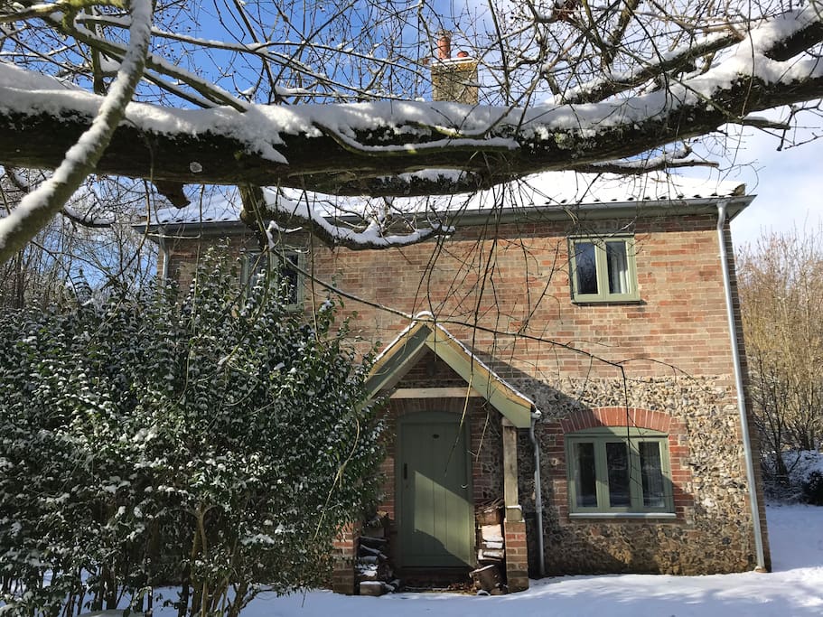 The old front door of the cottage, where wood is stored, two bedrooms above, and the sitting room and dining room below