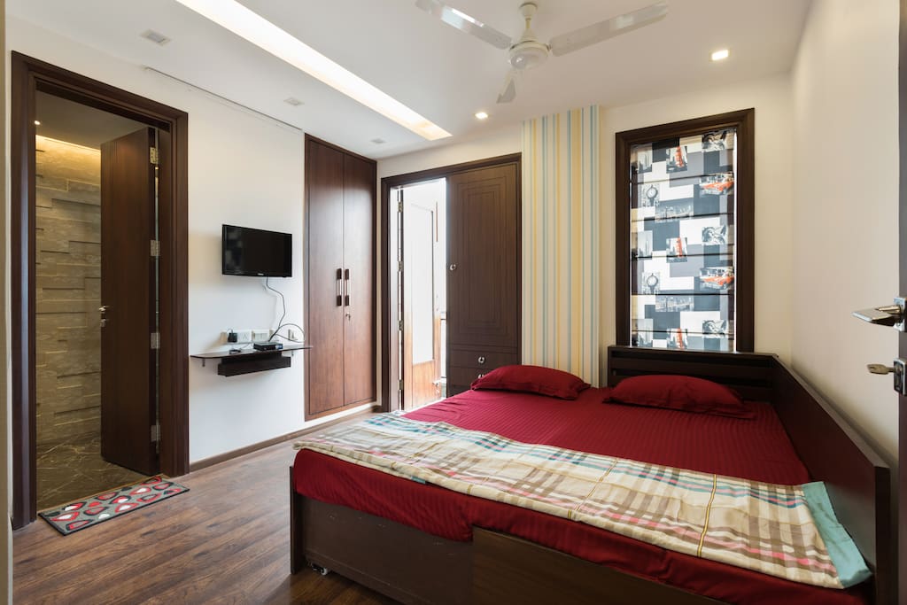 Well lit queen bedroom