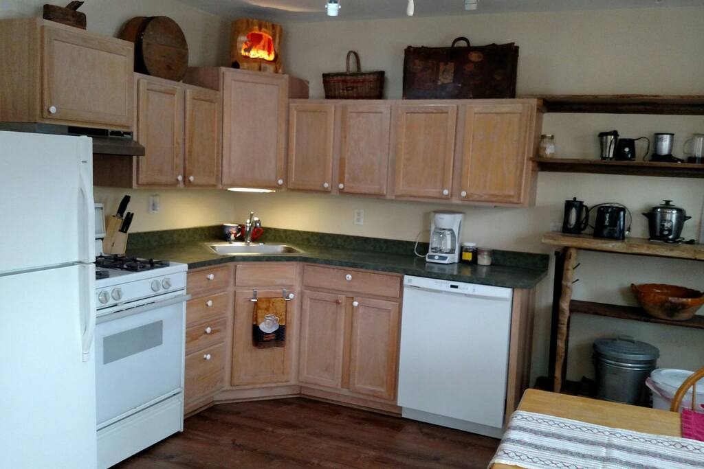 Kitchen with Magic Bullet, toaster, coffee makers, rice maker, pots and pans.