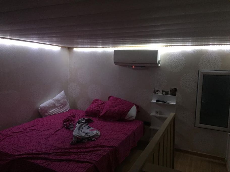 bed room with king size bed and ac