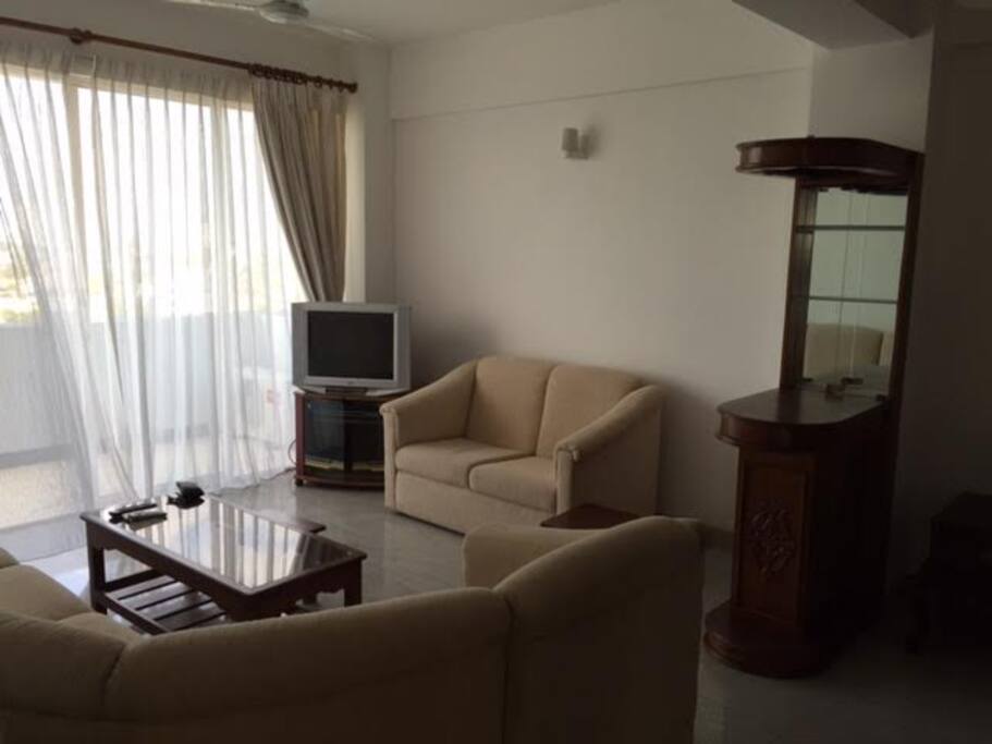 Large cozy sofa set, TV, mini bar, and balcony with a great view