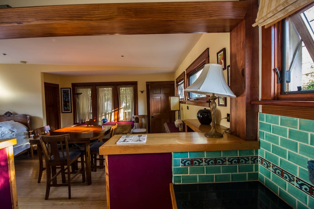 Standing in the kitchen one can see the entrance and the windows looking out into the neighborhood.