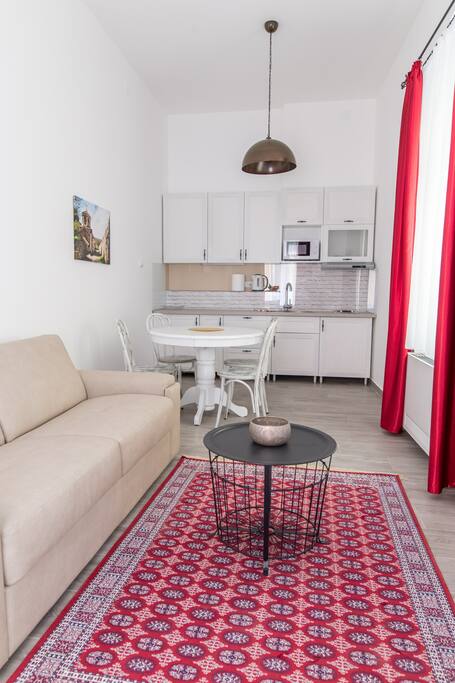 Living room with dining place and kitchen in behind