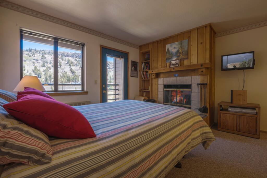 Queen Bed in front of fireplace