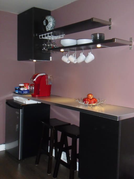 Kitchenette with mini-fridge, coffee maker and breakfast bar