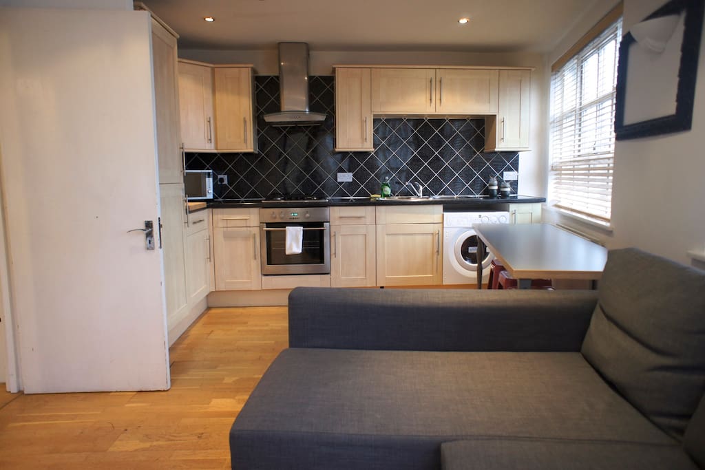 Here's the Living Room/Kitchen with Double Sofa Bed & Private Balcony