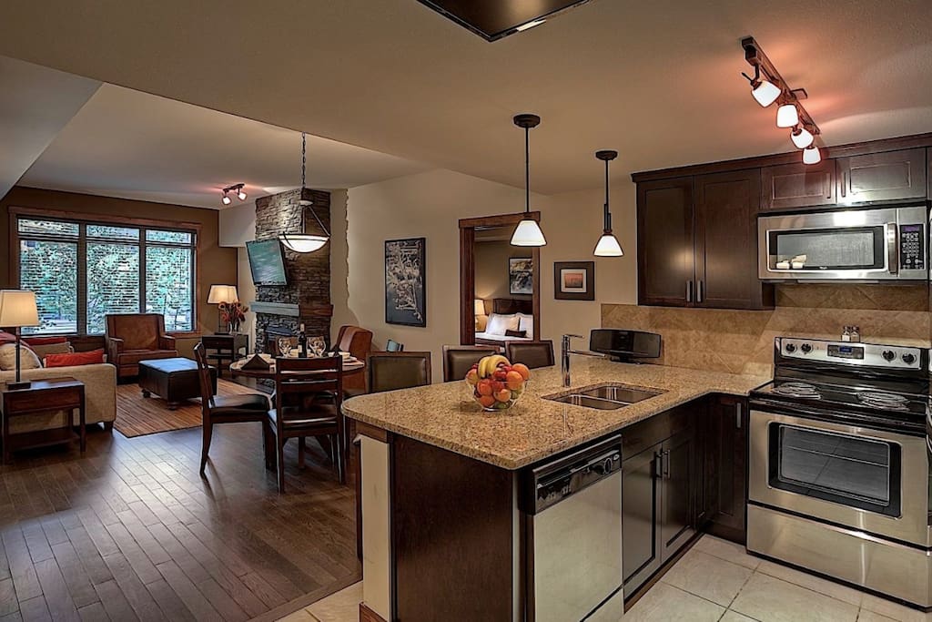 The sleek kitchen features stainless steel appliances and a breakfast bar.
