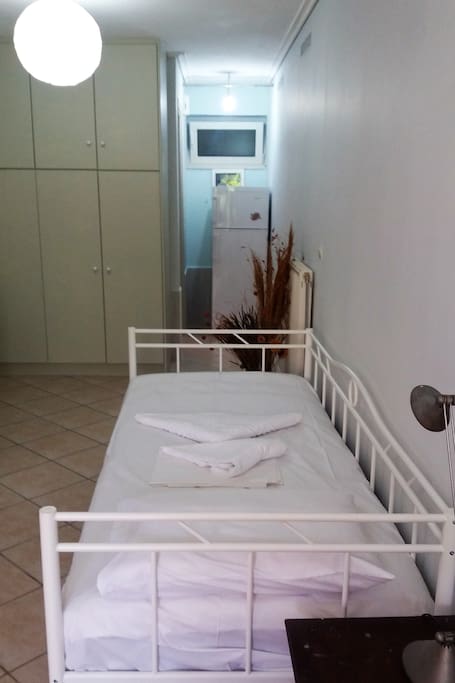 Primary bed (210x97cm brand new IKEA bed and matress) and the big fridge in the back