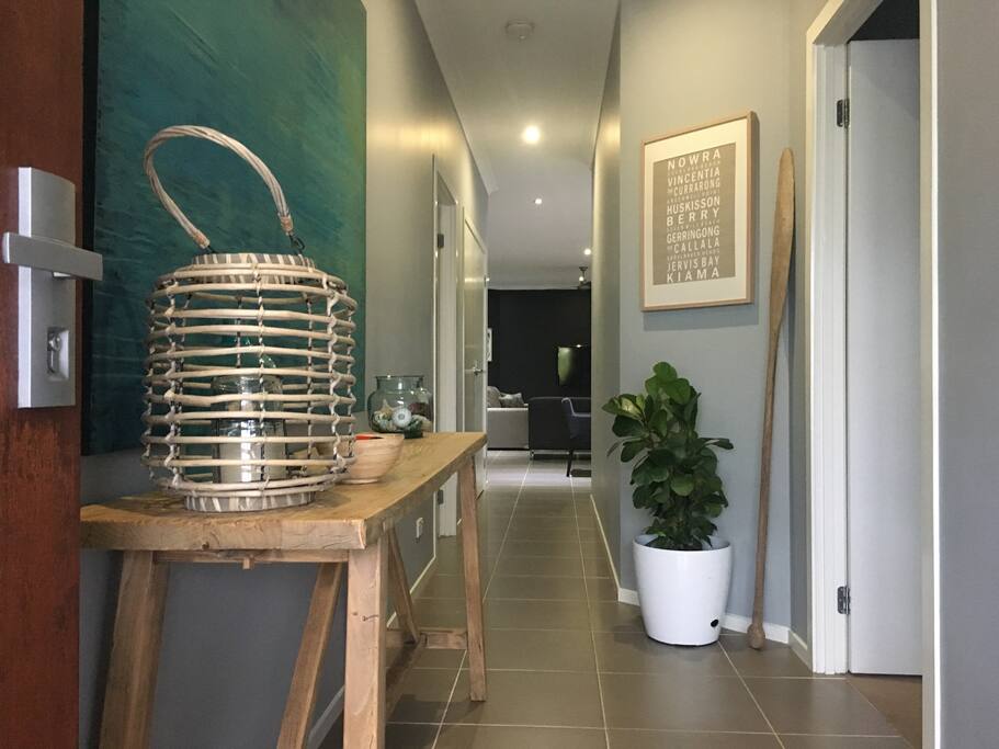 Entrance hallway to open plan areas with access to master bedroom and garage.