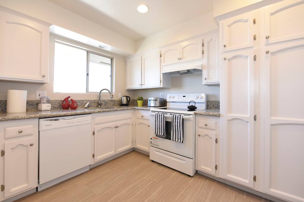 large full kitchen with all the kitchenware you need.