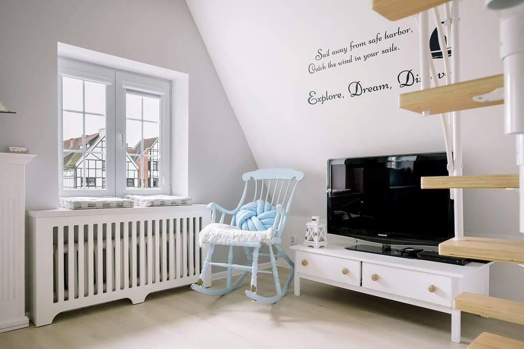 rocking chair in the living room, cable TV