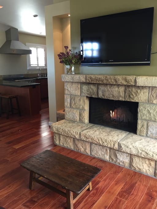 Both a gas and wood burning fireplace hand chiseled of classic Santa Barbara sandstone