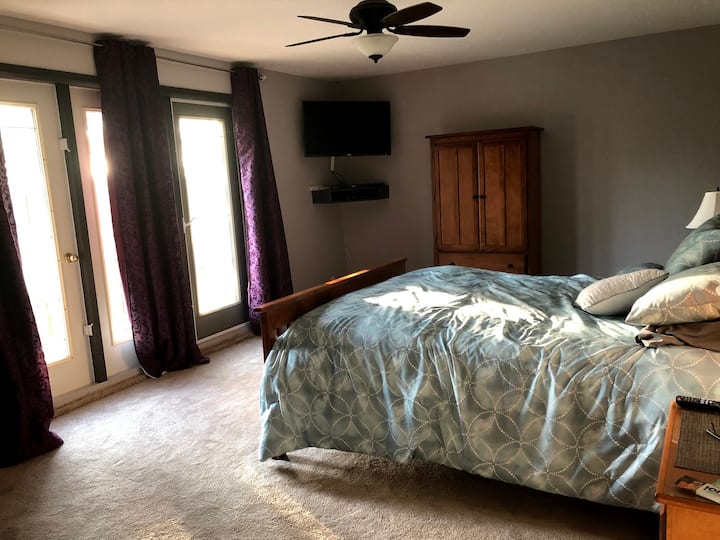 Bedroom 1 (master, queen) upstairs with balcony, TV