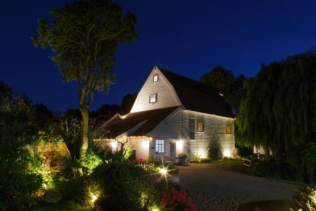 View of Mill building at night viewed from the patio of the Mill House